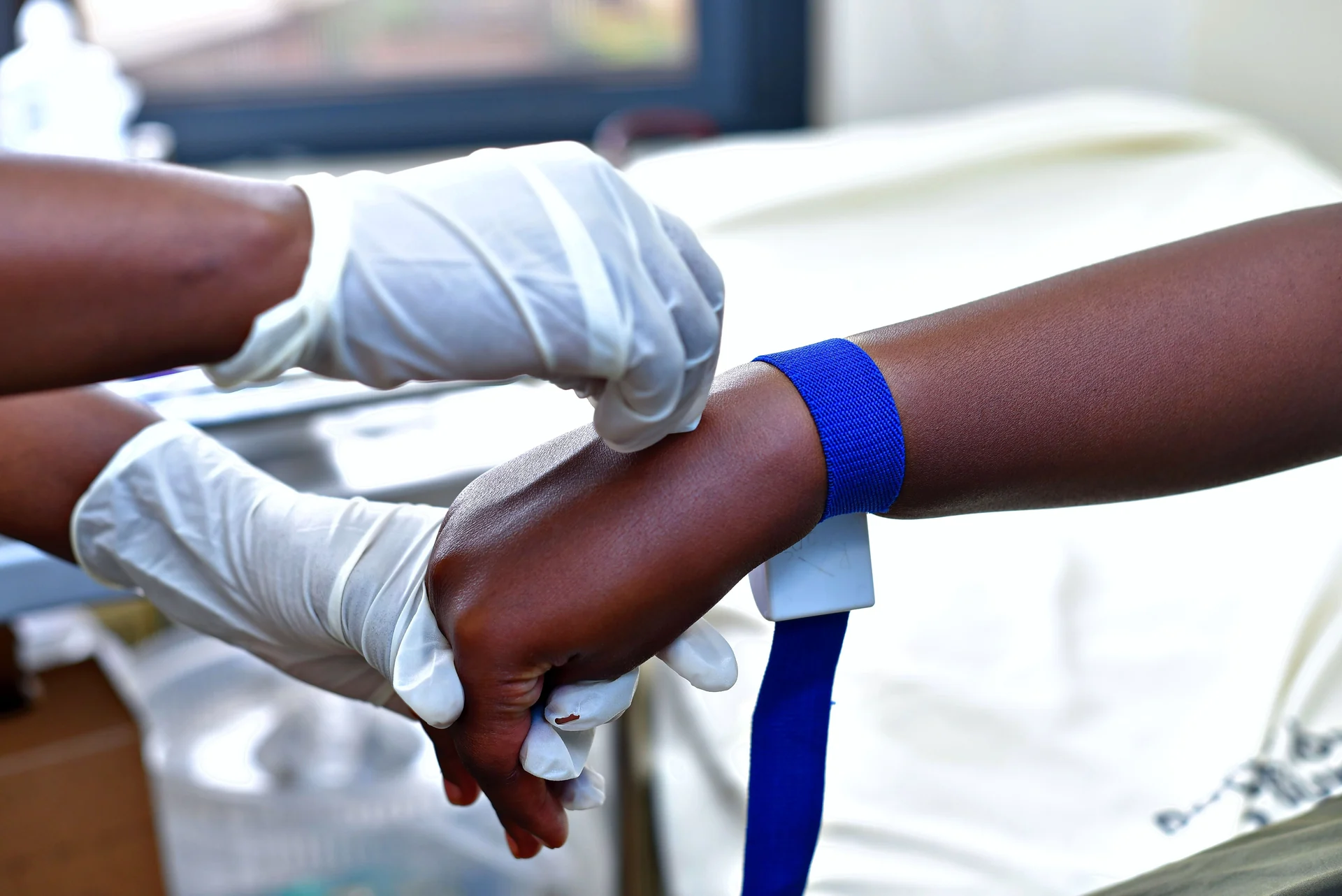A clinician preparing a patient for a blood sample
